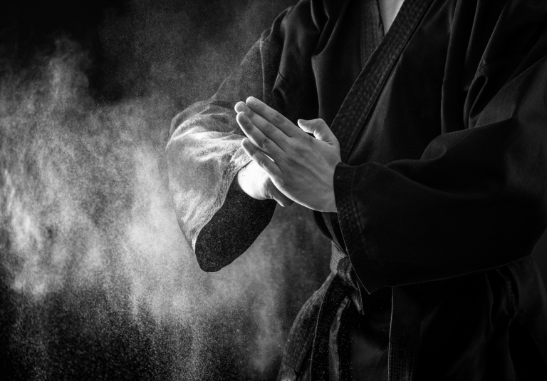 Closeup of male karate fighter hands. Black and white.